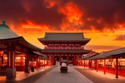 Japan, Tokyo. Asakusa Temple in red. Sensoji Temple under red sky. Buddhism concept. Buddhist temple without people. Asakusa Street with souvenir shops. Hand washing bowl in front of Buddhist temple