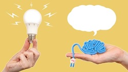 Human brain with plugged in. Concept of development of brain activity. Ideas for brain development. Light bulb in hand is metaphor inspiration. Stimulating mental activity. Dialogue cloud over brain