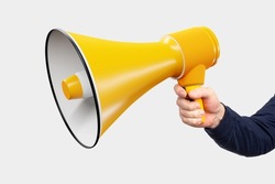 Loudspeaker in hand on white background. Loudspeaker as symbol of agitation and propaganda. Large yellow loudspeaker. Man with megaphone. Concept sale sound equipment. Isolated hand with gramophone