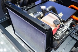 Cooling radiator inside car. Car radiator inside dismantled bonnet. Inside car. Concept - filter replacement. Installing new cooling filter. Engine cooling system repair. Car repair.