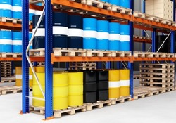 warehouse business. Warehouse for chemical products. Metal barrels of different colors. Production and storage of chemicals Pallets with barrels. Warehouse of toxic substances with racks