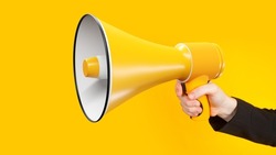Loudspeaker close-up. Megaphone in woman's hand. Yellow speaker. Megaphone as metaphor for propaganda and marketing. Loudspeaker for your advertising banner yellow megaphone close-up