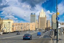 Moscow roads. Russian architecture. Cars drive along road in center of Moscow. Road architecture of capital. Moscow streets. Automobile travel to capital of Russia. Russian Federation.