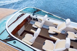 Speedy motor boat. Boat trips. An empty cabin of a motor boat. Leather seats and wooden trim of a luxury yacht. Sale of passenger ships. Recreation on the water.
