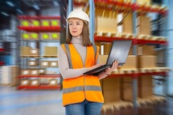 Customs clearance. Warehouse woman. Employee of company for customs services. Girl with laptop in logistics warehouse. Woman in orange vest works at customs. Storekeeper career concept. Art focus