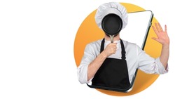 A male chef covers his face with a frying pan. The chef is joking on the smartphone screen. Culinary humor. Cooking online. Cooking according to the online course. A mobile app for teaching cooking.