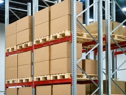 Cardboard boxes on warehouse shelves. Steel racks with pallets. Warehouse of distribution company. Warehouse logistics manufacturing enterprises concept. Concept renting place to store company goods