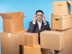 Tired entrepreneur. Business man among boxes. Man surrounded by parcels. Entrepreneur suffers from overwork. Concept of tired businessman can not cope with orders. Tired guy in business suit