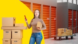 Rental Storage Units. Woman in warehouse building. Girl rents place to store things. Doors to self storage are closed. Lady with phone. Cargo trolley with cardboard boxes. Storage rental via phone