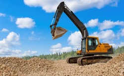 Crawler excavator. Construction works. Crawler excavator under blue sky. Excavator is engaged in construction work. Site preparation for builders. Concept of sale of construction equipment