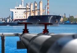 Oil pipeline. Petroleum transport ship. Oil tanker. Trumpet in seaport. Harbor for loading oil onto ship. Pipeline for refueling ships with fuel. Ship harbor in sunny day. Fuel infrastructure port