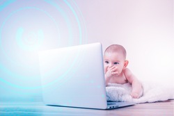 Baby playing learning on the laptop early development next generation z big data concept fast learning overlay