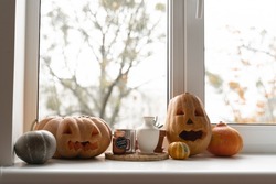 Carved pumpkins for halloween. home decor on window. thanksgiving 