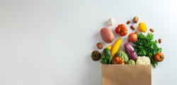 Delivery healthy food background. Healthy vegan vegetarian food in paper bag vegetables and fruits on white, copy space, banner. Shopping food supermarket and clean vegan eating concept