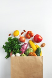 Delivery healthy food background. Healthy vegan vegetarian food in paper bag vegetables and fruits on white, copy space. Shopping food supermarket and clean vegan eating concept