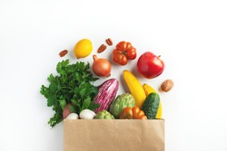 Healthy food background. Healthy vegan vegetarian food in paper bag vegetables and fruits on white, copy space. Shopping food supermarket and clean vegan eating concept.