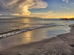 Salthill beach at dusk, dramatic sky over Burren mountains, Galway bay, Galway city, Ireland.