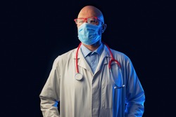 Portrait of a bold male doctor on a dark background. Man in his 40s, in white uniform red glasses and stethoscope. Teal and blue color.