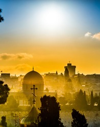 Jerusalem roofs: Dome of the Rock and the Russian church of Mary Magdalene, church steeples of the Old City, fortified wall of the Tower of David and high rise hotel of West Jerusalem in a sunset haze
