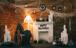 Cozy Halloween decorations with a fireplace and festive attributes. Photozone for Halloween. Background