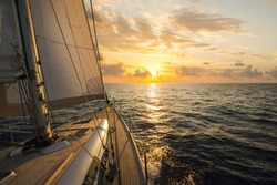 Sailboat sailing in the Mediterranean Sea at sunset