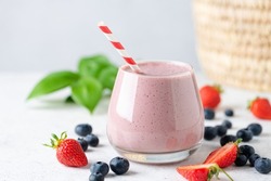 Delicious pink berry fruit smoothie in glass. Healthy vegan smoothie or vegan milkshake with soy milk and berries