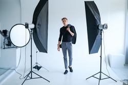 backstage self-confident man equipment workplace photo studio concept. Photography of fashion look.