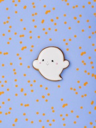 Traditional spooky character. Cute happy ghost with baby face. Ghost shaped treats. Homemade ginger cookies. Minimalist Halloween background. 