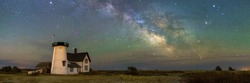A panoramic view of the Milky Way Galaxy over Stage Harbor Lighthouse at Hardings Beach in Chatham, Massachusetts.