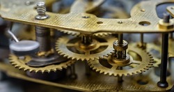 close up of cogwheels in clockwork