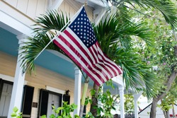 American flag attached to porch of house
