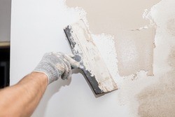 Process putty concrete wall with a metal spatula.process of applying a layer of putty. Renovation of apartments. Repair the walls. Free space for advertising, text.Repair of the living quarters.