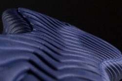 Fragment of a blue sole of a sneaker. The texture of the material of sports shoes