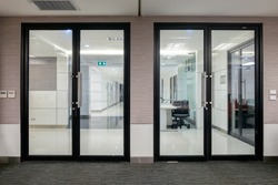 Empty glass door with black Aluminium frame in office building for wall backgroud