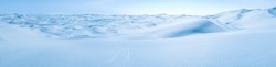 Big snow and ice dunes panorama with tire marks. Arctic Snowball Earth.