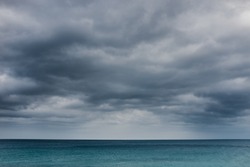 Calm and moody seascape with a dramatic sky before storm. 