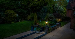 A view of garden lights on a brick wall in Market Harborough, UK at night