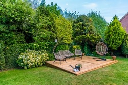 A new wooden deck in a garden in Market Harborough, UK in early summer