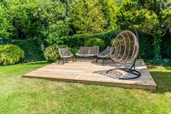 A completed decking construction in a garden in Market Harborough, UK in early summer