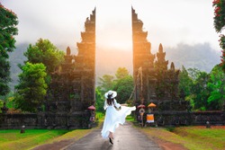 Asian female tourists visit Bali gate in Bali,Indonesia