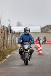 motorcycle driving school. a woman learns to drive before obtaining a driving license. 