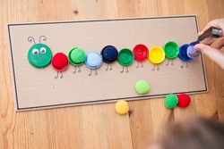 Plastic bottle caps worm. Put correct color pom poms in centipede caterpillar. 5 minute crafts. DIY children home activity. Early education, fine motoric skills. #stay at home.