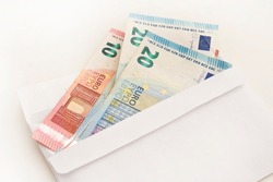 Bunch of Euro's. Close-up. Saving money. Keeping savings at home. Open envelope with Euro banknotes out from it. Finance, savings, investing. Money management at home. Financial business concept.