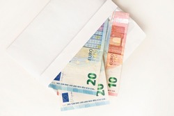 Bunch of Euro's. Close-up. Saving money. Keeping savings at home. Open envelope with Euro banknotes out from it. Finance, savings, investing. Money management at home. Financial business concept.