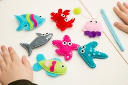Hand made stuffed felt toy. Fishing rod with magnet and fishes or other sea animals. Different colors. Safe eco stuffed toy for infants and toddlers. Early education implement. 