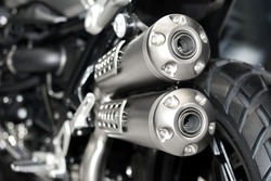 Closeup of exhaust or intake of racing motorcycle. Low angle photograph of motorcycle.