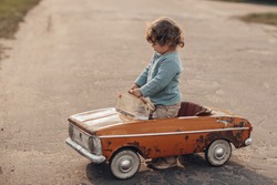Kid driving a toy car