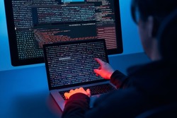 Man using computer and programming  to break code. Cyber security threat. Internet and network security. Stealing private information. Person using technology to steal password and private data. Cyber