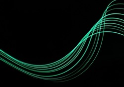Long exposure light painting photograph of neon green fairy lights in an abstract parallel lines swirl pattern against a black background