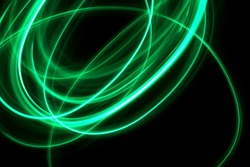 Green Light Painting Photography, loop and swirl against a black background